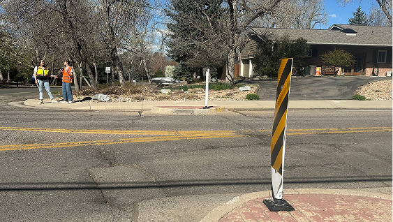 Concrete curbs to narrow the roadway at a traffic circle